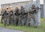 Georgia Army National Guardsmen with the 2nd Battalion, 121st Infantry Regiment, 48th Infantry Brigade Combat Team, stack against a wall during an Exportable Combat Training Capability Exercise at Fort Stewart, Ga., June 18, 2022. The XCTC exercise included approximately 4,400 brigade personnel from throughout Georgia.