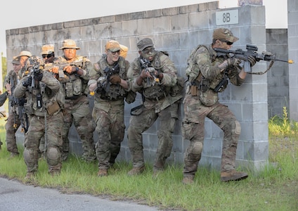 Georgia Army National Guardsmen with the 2nd Battalion, 121st Infantry Regiment, 48th Infantry Brigade Combat Team, stack against a wall during an Exportable Combat Training Capability Exercise at Fort Stewart, Ga., June 18, 2022. The XCTC exercise included approximately 4,400 brigade personnel from throughout Georgia.