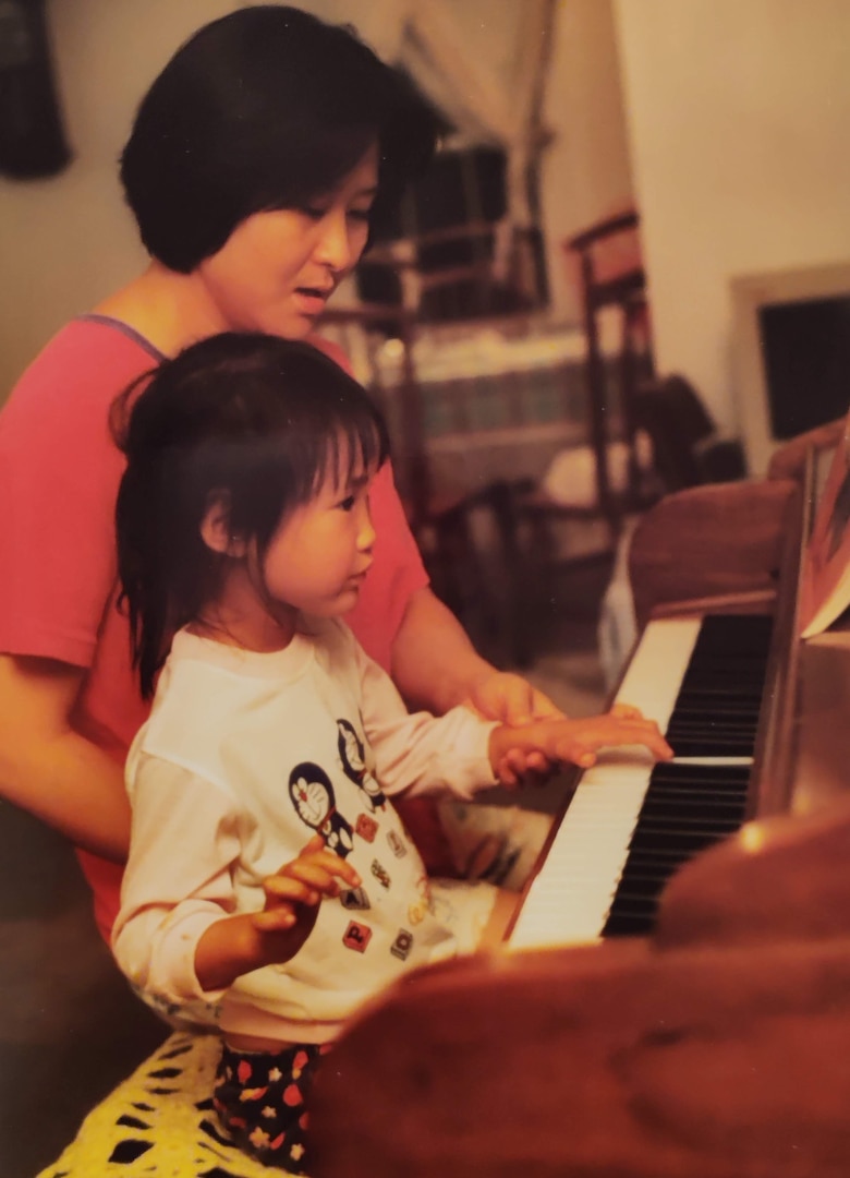 A young Spc. Jessica Tang practices her piano skills.