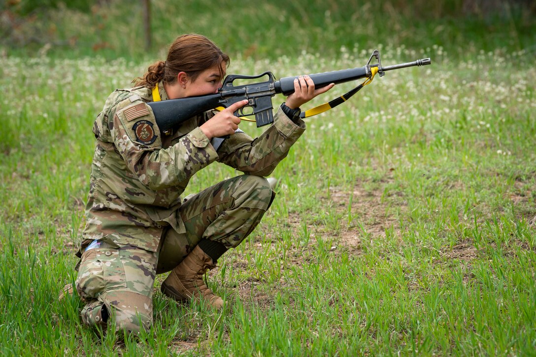A cadet aims her weapon.