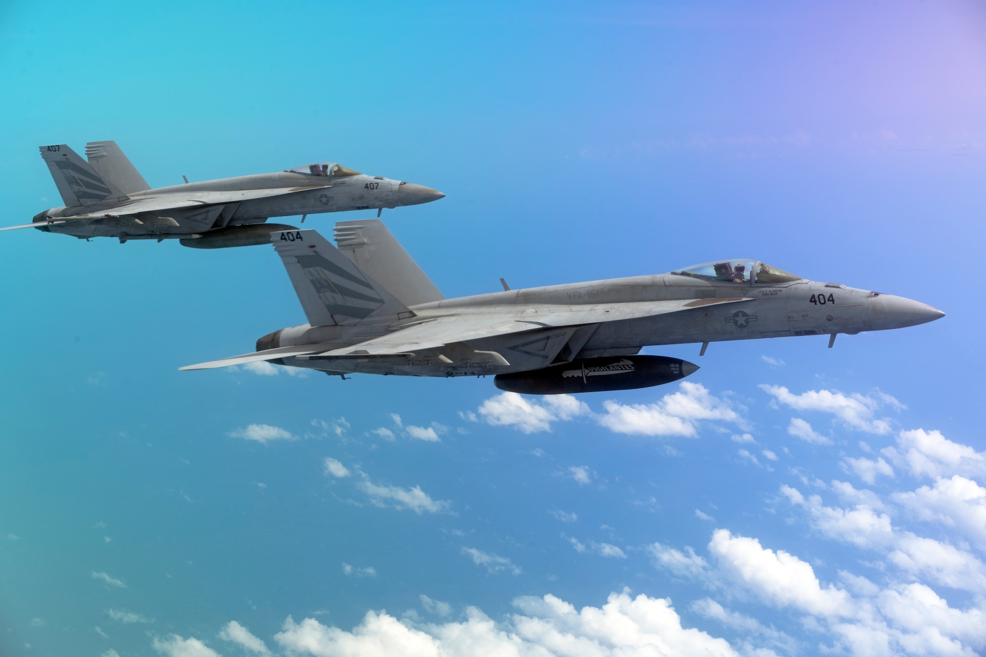 Two U.S. Navy F/A-18 Hornets fly in formation with a McConnell Air Force Base, Kansas, KC-46A Pegasus June 6, 2022, located above the Pacific Ocean during Air Mobility Command’s Employment Concept Exercise 22-06. The exercise tested McConnell and Pease Air National Guard Base, N.H., airframes and aircrew to practice joint interoperability in a multi-domain environment to build real-world proficiency. (U.S. Air Force photo by Master Sgt. John Gordinier)
