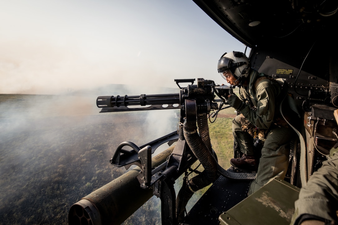 Cpl. Monica Pomales, a crew chief with Marine Light Attack Helicopter Squadron (HMLA) 773 Detachment A, 4th Marine Aircraft Wing, from Deerfield Beach, Florida, conducts live fire shooting drills in a UH-1Y Venom during exercise Gunslinger 22 at Smoky Hill Range, Kansas on June 17, 2022. Exercise Gunslinger 22 is a joint exercise with the Kansas National Guard and U.S. Marine Corps designed to increase aircraft control and training for potential real world contingencies. (U.S. Marine Corps photo by Lance Cpl. David Intriago)