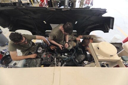 Mechanics from military police units turn wrenches during Operation Platinum Wrench