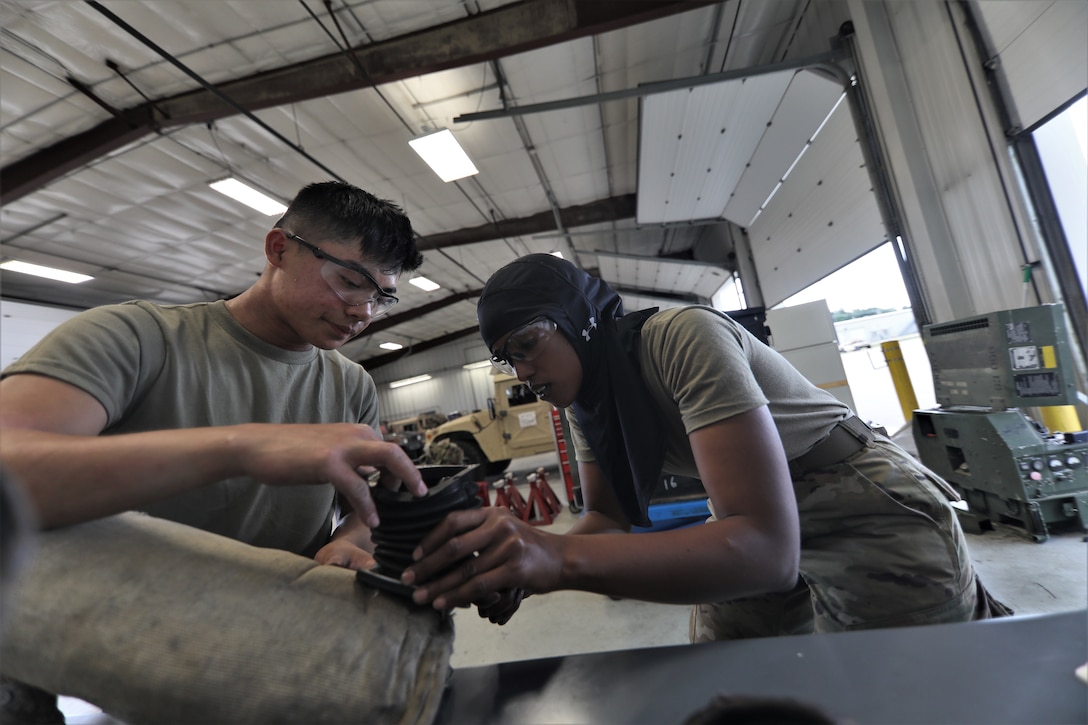 Mechanics from military police units turn wrenches during Operation Platinum Wrench