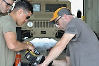 Mechanics from military police units turn wrenches during Operation Platinum Wrench