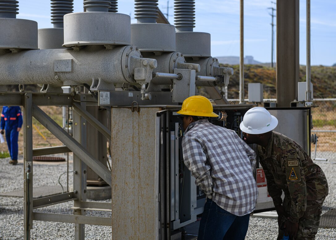 Mr. Volkmer Garcia, left, electrical engineering technician, and Staff Sgt. Quinterrall Brown, right, NCOIC of mission engineering, assigned to the 30th Civil Engineer Squadron, check a power panel at substation N on Vandenberg Space Force Base. Airmen and civilians assigned to the 30th Civil Engineer Squadron, along with contractors, successfully routed power to substation N, re-energizing south loop two. (U.S. Space Force photo by Airman 1st Class Ryan Quijas)