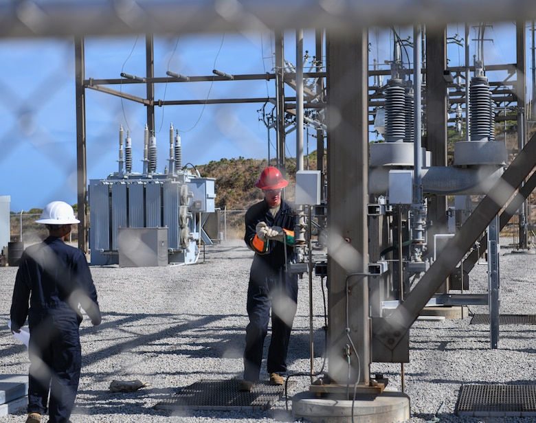 Airman 1st Class Jared Shoemaker, right, electrical systems apprentice, turns a crank at substation N on Vandenberg Space Force Base, Calif., June 2, 2022. Airmen and civilians assigned to the 30th Civil Engineer Squadron, along with contractors, successfully routed power to substation N, re-energizing south loop two. (U.S. Space Force photo by Airman 1st Class Ryan Quijas)