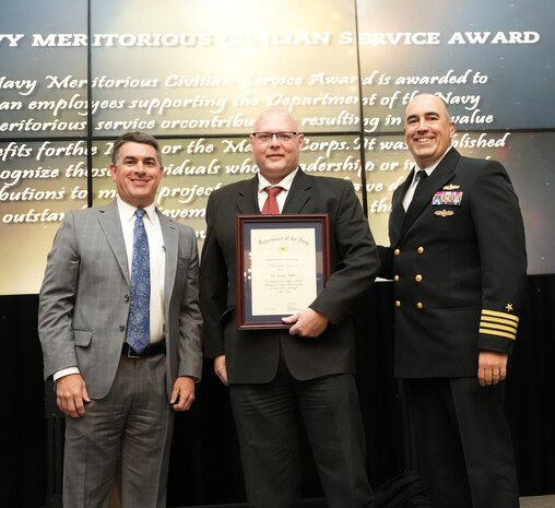 IMAGE: Dr. Tony Buhr receives the Navy Meritorious Civilian Service Award at the 2021 Naval Surface Warfare Center Dahlgren Division (NSWCDD) Honorary Awards ceremony, June 17. Standing left to right: NSWCDD Technical Director, Dale Sisson, SES, Buhr and NSWCDD Commanding Officer, Capt. Philip Mlynarski.