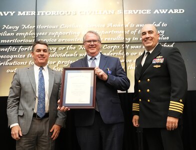 IMAGE: Roger Carr receives the Navy Meritorious Civilian Service Award at the 2021 Naval Surface Warfare Center Dahlgren Division (NSWCDD) Honorary Awards ceremony, June 17. Standing left to right: NSWCDD Technical Director, Dale Sisson, SES, Carr and NSWCDD Commanding Officer, Capt. Philip Mlynarski.