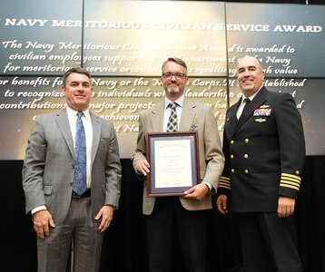 IMAGE: Chad Finch receives the Navy Meritorious Civilian Service Award at the 2021 Naval Surface Warfare Center Dahlgren Division (NSWCDD) Honorary Awards ceremony, June 17. Standing left to right: NSWCDD Technical Director, Dale Sisson, SES, Finch and NSWCDD Commanding Officer, Capt. Philip Mlynarski.