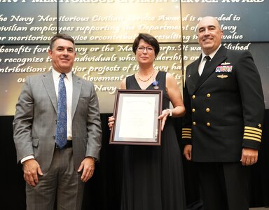 IMAGE: Robin Ross receives the Navy Meritorious Civilian Service Award at the 2021 Naval Surface Warfare Center Dahlgren Division (NSWCDD) Honorary Awards ceremony, June 17. Standing left to right: NSWCDD Technical Director, Dale Sisson, SES, Ross and NSWCDD Commanding Officer, Capt. Philip Mlynarski.