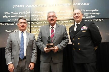 IMAGE: Kenneth Clements receives the John Adolphus Dahlgren Award at the 2021 Naval Surface Warfare Center Dahlgren Division (NSWCDD) Honorary Awards ceremony, June 17. Standing left to right: NSWCDD Technical Director, Dale Sisson, SES, Clements and NSWCDD Commanding Officer, Capt. Philip Mlynarski.