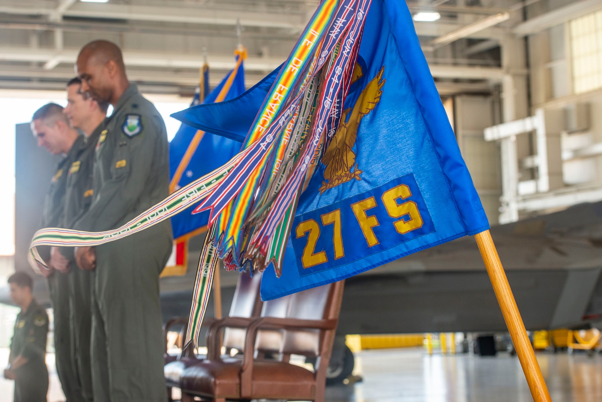 A guidon waves during a moment of silence.