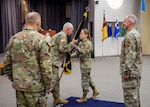 Army Col. Catherine L. Cherry receives the colors of the National Guard Professional Education Center from Lt. Gen. Jon A. Jensen, director of the Army National Guard, as she took command of the center during a change of command ceremony at the PEC’s Militia Hall at Camp Joseph T. Robinson, Arkansas, June 16, 2022. Cherry is the first woman to command the PEC, which was established as a training center in 1974.