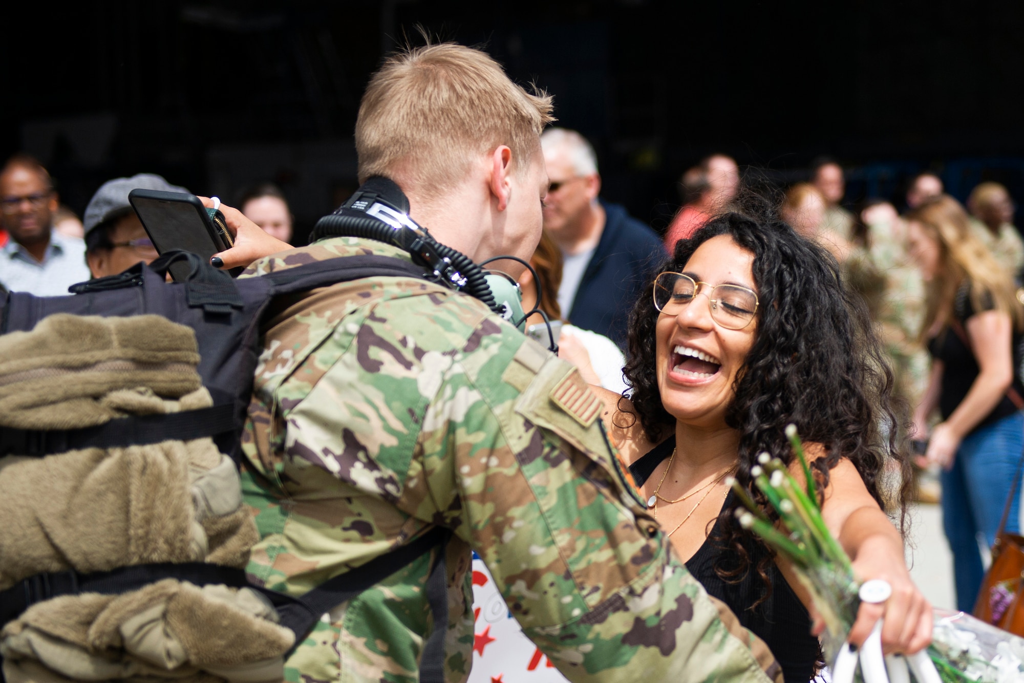 Sofia Garduño runs to meet her boyfriend Senior Airmen Josiah Goodman, 934 Maintenance Squadron aerospace propulsion technician, after returning from a three-month deployment to Europe on May 19, 2022, at Minneapolis-St. Paul Air Reserve Station. The 934th Airlift Wing performed tactical airlifts and vital aeromedical evacuations in support of U.S. European Command to assure our Allies and Partners in the region and deter any future aggression. (U.S. Air Force Picture by Chris Farley)