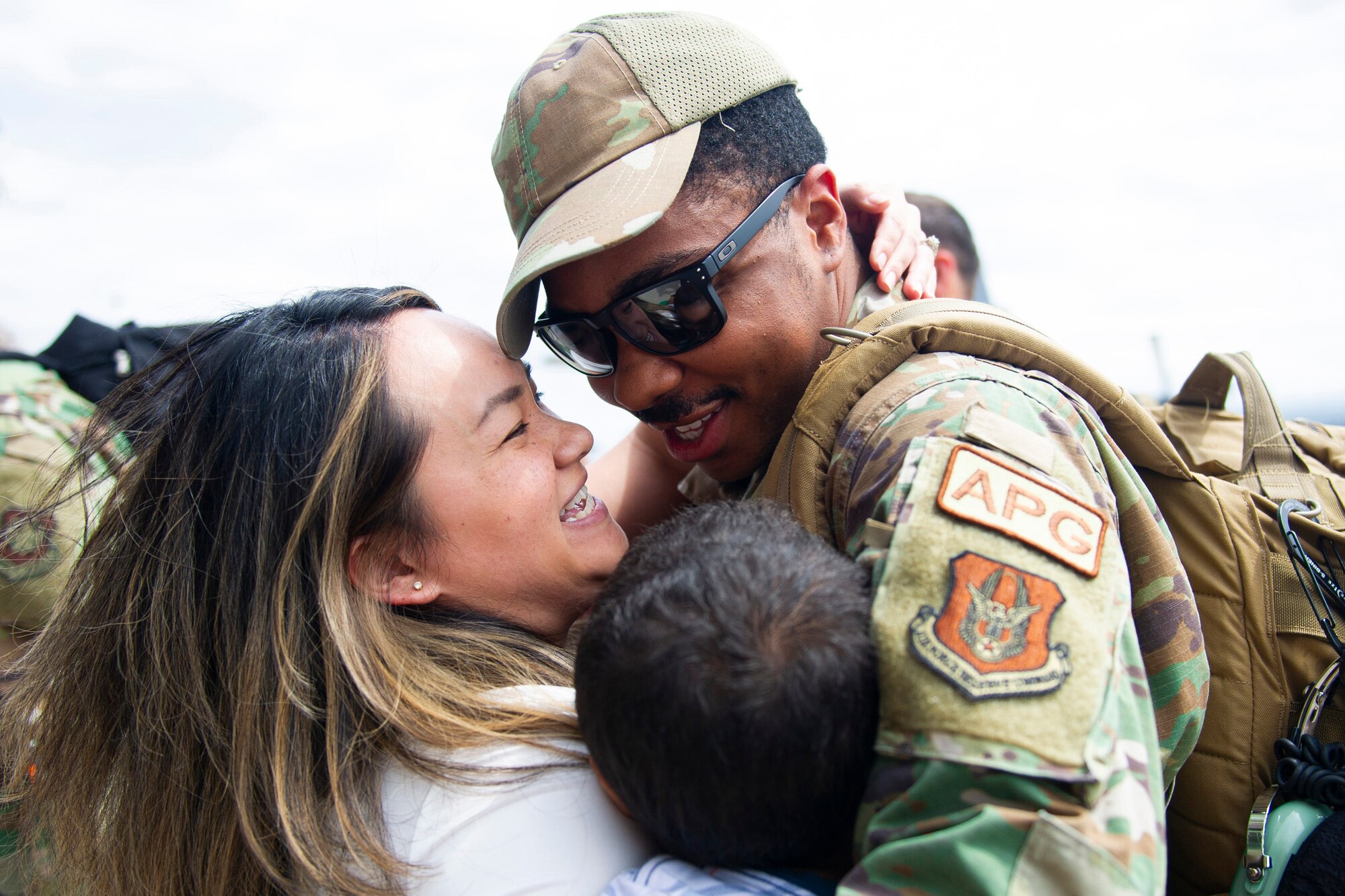 Staff Sgt. Darrell Anderson, 934th Aircraft Maintenance Squadron, hugs his wife Felicia and son after returning from a three-month deployment to Europe on May 19, 2022, at Minneapolis-St. Paul Air Reserve Station. The 934th Airlift Wing performed tactical airlifts and vital aeromedical evacuations in support of U.S. European Command to assure our Allies and Partners in the region and deter any future aggression. (U.S. Air Force Picture by Chris Farley)