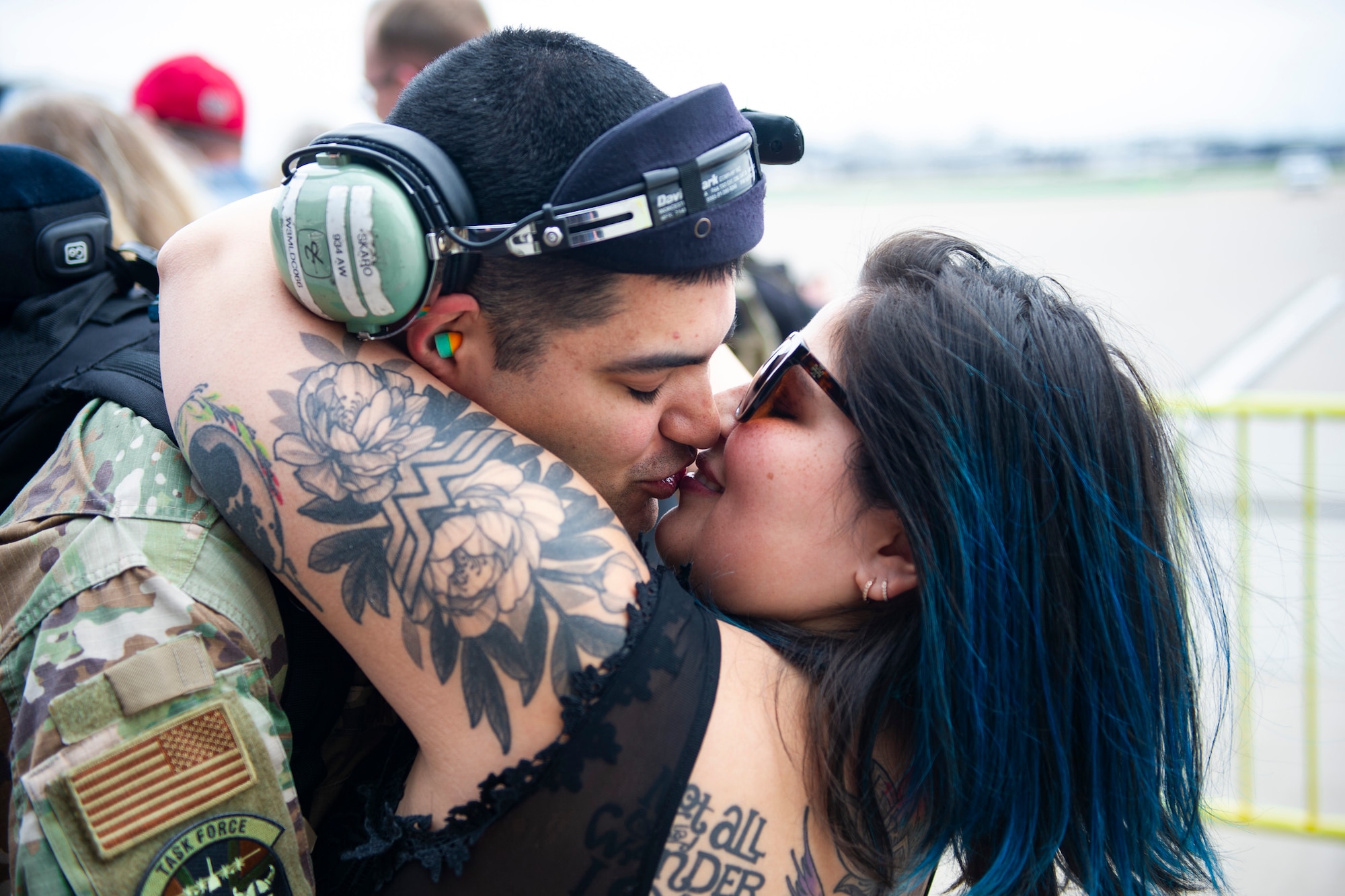 Tech Sgt. Matthew Skaro, 934th Aircraft Maintenance Squadron crew chief, hugs and kisses his wife after returning from a three-month deployment to Europe on May 19, 2022, at Minneapolis-St. Paul Air Reserve Station. The 934th Airlift Wing performed tactical airlifts and vital aeromedical evacuations in support of U.S. European Command to assure our Allies and Partners in the region and deter any future aggression. (U.S. Air Force Picture by Chris Farley)