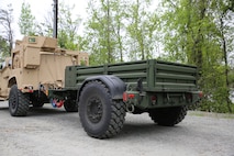 The Marine Corps’ new JLTV-Trailer comes loaded with features such as a step assist in the rear, air brakes, removable side rails, a 12v electrical hook in the front and a storage compartment. Offering 147 cubic feet of storage space and already coming painted green from the factory, the JLTV-T propels the light tactical vehicle fleet toward Force Design 2030. Marine Expeditionary Units and Divisions are expected to concurrently receive initial shipments of the trailer beginning fiscal year 2022. (U.S. Marine Corps photo by Samantha Bates)