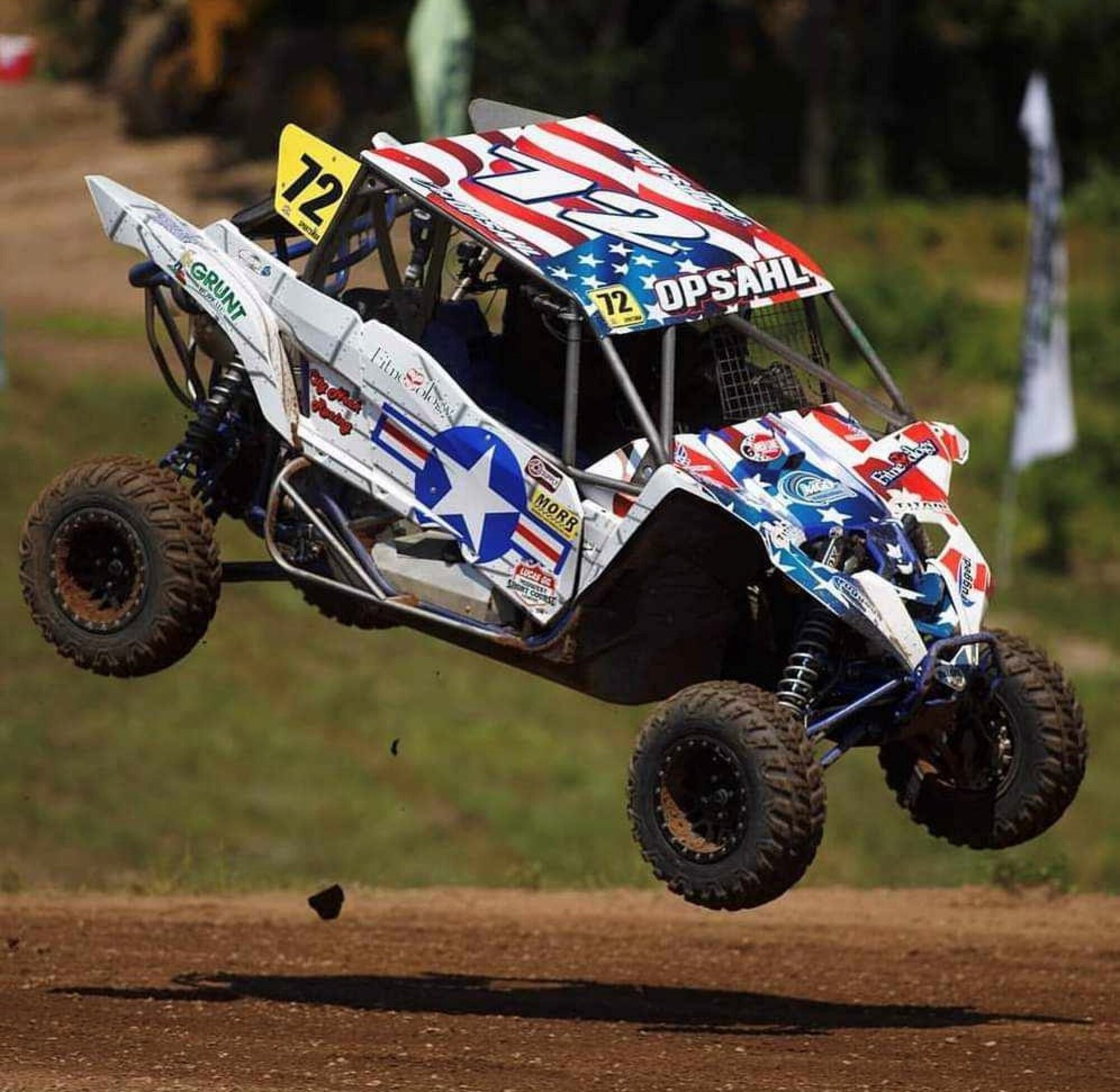 Staff Sgt. Josiah Opsahl rides off-road in his Air Force-inspired wrapped utility task vehicle during his first race in the Amsoil Championship the first week of June 2022 at the Antigo Lions Roaring Raceway in Wisconsin near his hometown