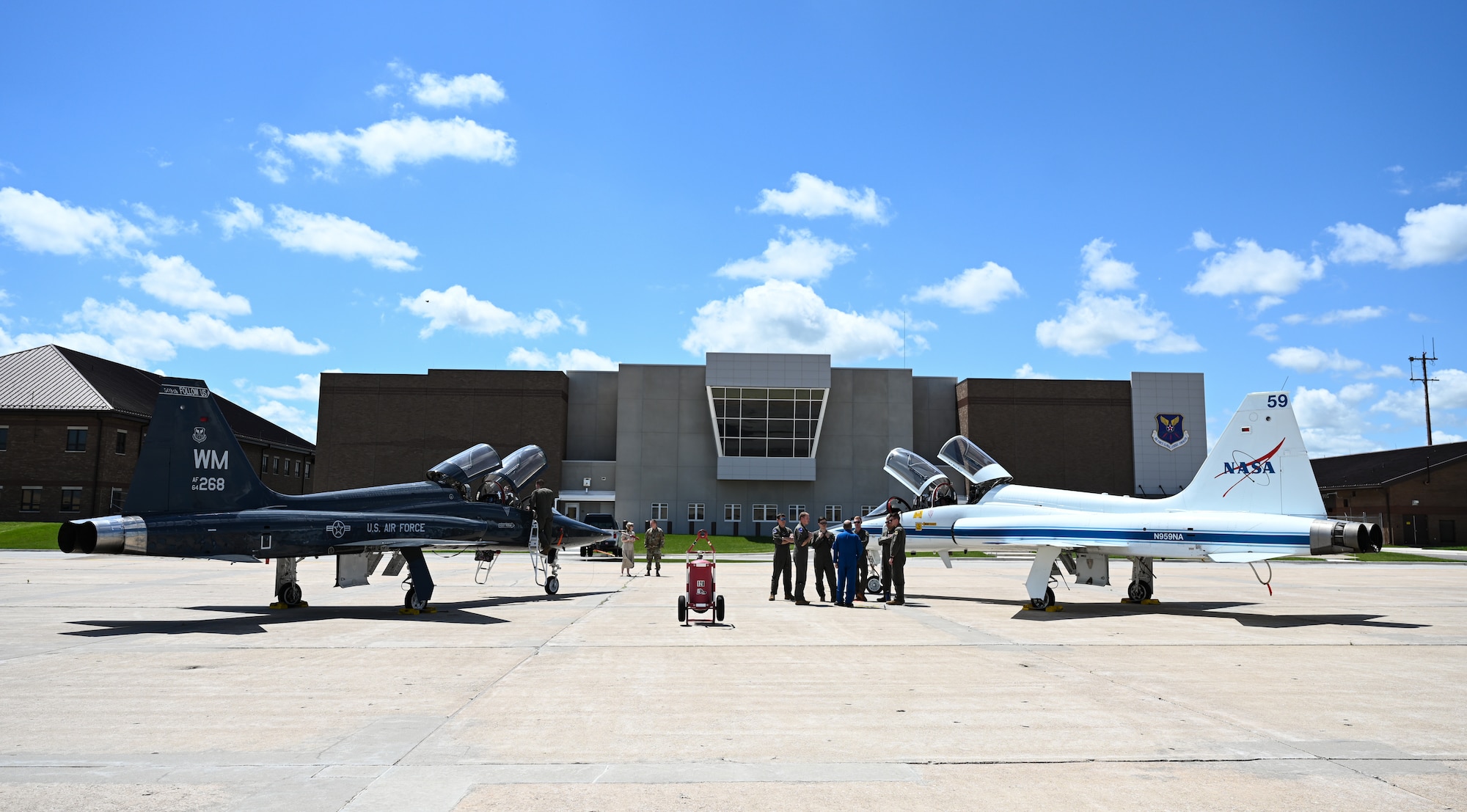 U.S. Air Force Airmen and NASA personnel discuss the T-38N Talon at Whiteman Air Force Base, Missouri, June 7, 2022. NASA employs the T-38N Talon to prepare astronauts and aircrews to respond to events that may jeopardize the mission. Both NASA and the 509th Bomb Wing utilize the T-38 to enhance training so personnel are ready when the mission calls.