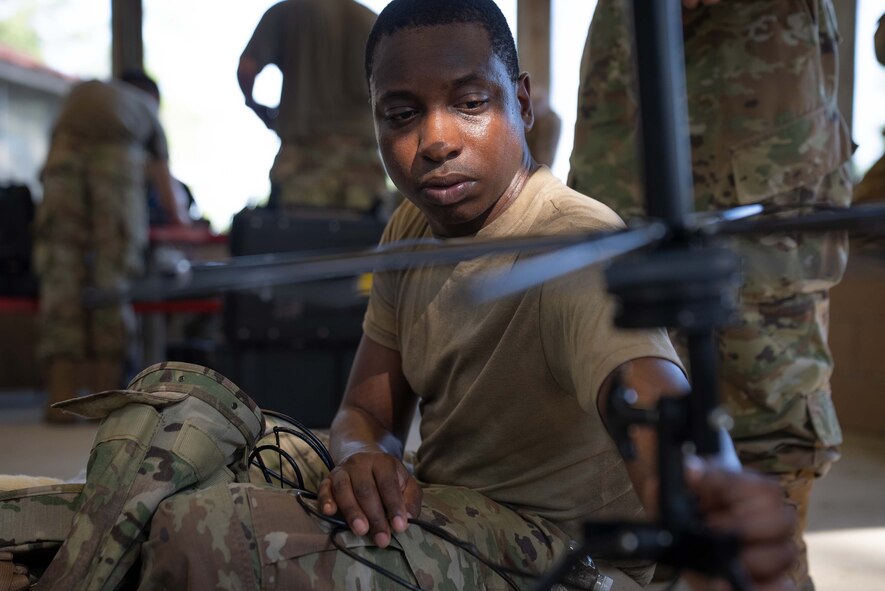 An Airman constructs an antenna.