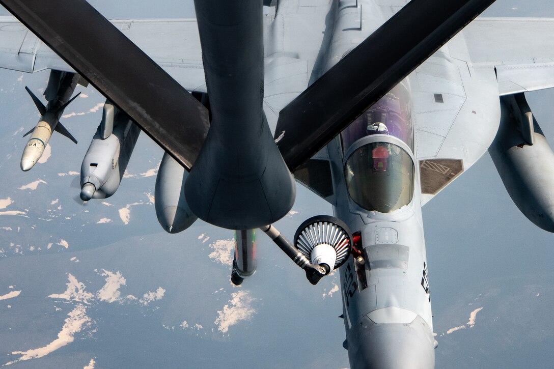 A Navy EA-18G performs an aerial refueling.