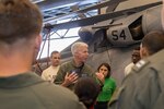 PACIFIC OCEAN (June 16, 2022) – Vice Adm. Karl Thomas, Commander, U.S. 7th Fleet, center, speaks with Sailors assigned to Helicopter Sea Combat Squadron (HSC) 23 in the hangar bay aboard amphibious assault carrier USS Tripoli (LHA 7), June 16, 2022. Tripoli is operating in the U.S. 7th Fleet area of operations to enhance interoperability with allies and partners and serve as a ready response force to defend peace and maintain stability in the Indo-Pacific region.  (U.S. Navy photo by Mass Communication Specialist 1st Class Peter Burghart)