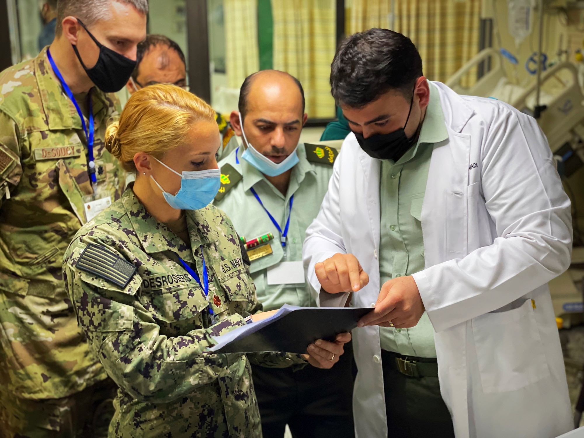 Dr. Rabadi, Jordanian Royal Medical Service intensive care unit doctor, and Lt. Cmdr. Taylor DesRosiers, Walter Reed Medical Center critical care fellow, review a patient’s paperwork inside the intensive care unit at the King Hussein Medical Center May 9, 2022 in Amman, Jordan.