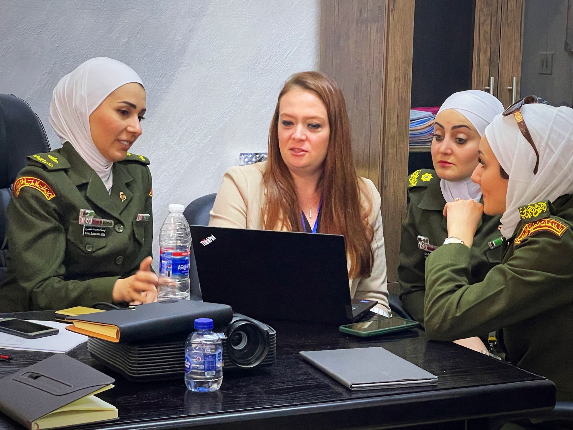 Lt. Col. Dana Mayer, Brooke Army Medical Center trauma nurse clinician, discusses record keeping practices alongside several Jordanian Royal Medical Service nurses inside the King Hussein Medical Center May 11, 2022 in Amman, Jordan.