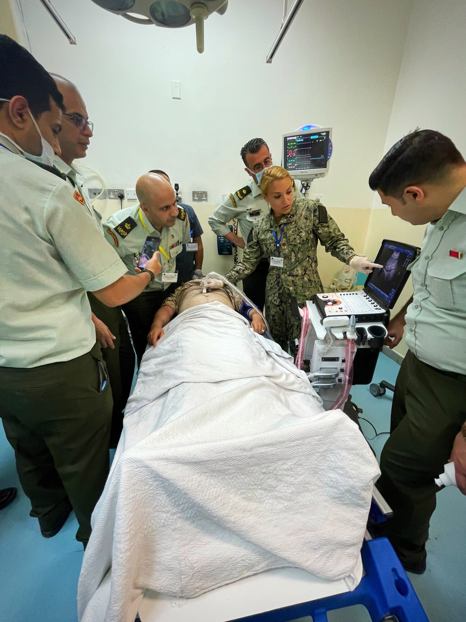 Lt. Cmdr. Taylor DesRosiers, Walter Reed Medical Center critical care fellow, points to a structure on an ultrasound machine screen while providing a demonstration of various techniques on a volunteer inside the King Hussein Medical Center May 9, 2022 in Amman, Jordan.