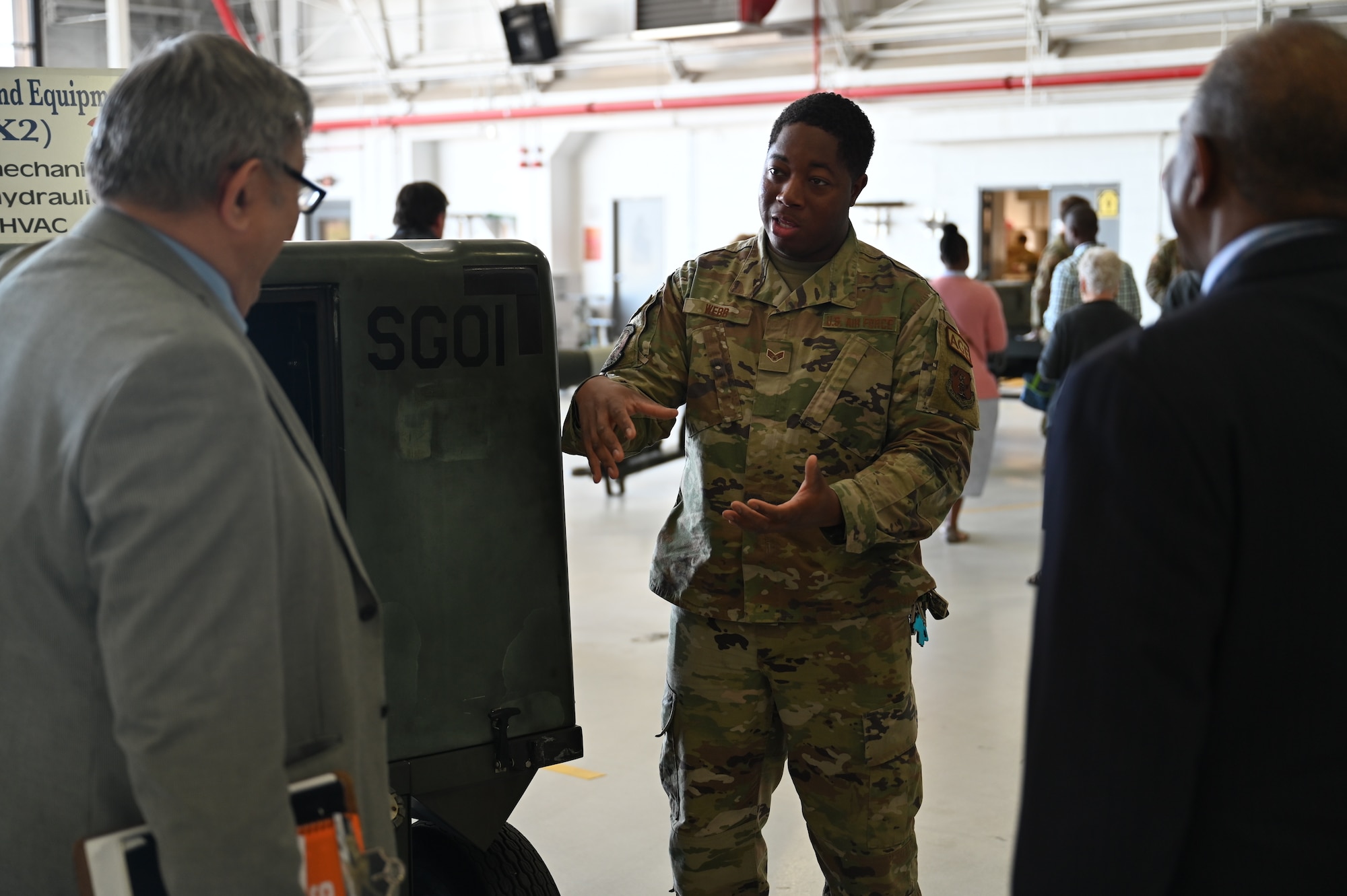 Senior Airman Shawn Webb, a member of the New York Air National Guard's 174th Attack Wing Maintenance Group, talks about the MQ-9 Reaper remotely piloted aircraft to local clergy members and the role his element plays in maintaining the aircraft on June 14, 2022. This was part of the Clergy Day event held at the base. The purpose of the event was to show the clergy community what we do and to thank them for their support to our members. (U.S. Air National Guard photo by Staff Sgt. Ty-leal Hodge)