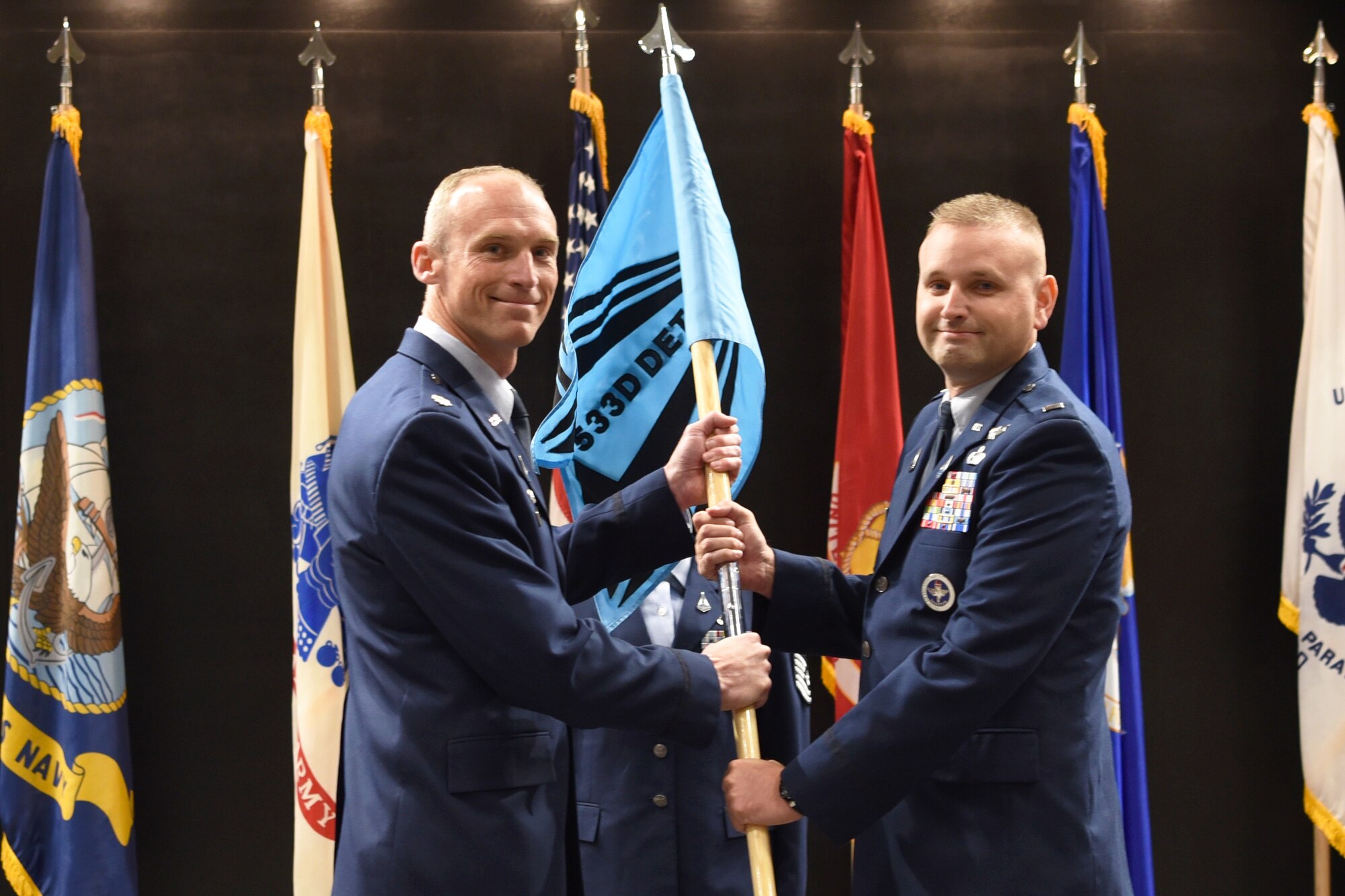 U.S. Space Force 1st Lt. Robert Freeman, right, assumes responsibility from Lt. Col. Charles Cooper, 533rd Training Squadron commander, during the activation and assumption of responsibility for 533rd TRS, Detachment 1, at the Powell Event Center, Goodfellow Air Force Base, Texas, June 21, 2022. Freeman was designated the detachment chief for 533rd TRS. (U.S. Space Force photo by Senior Airman Abbey Rieves)