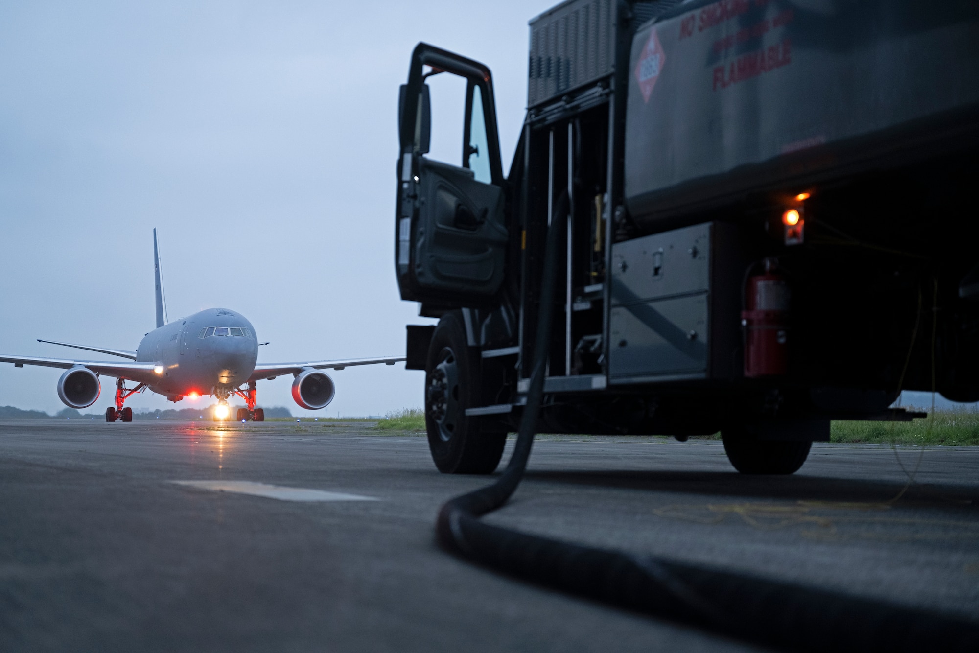 A KC-46A Pegasus from McConnell Air Force Base, Kansas, taxis down the ramp as another Pegasus is being refueled for the next day’s mission June 8, 2022, at Yokota Air Base, Japan. The KC-46As conducted Air Mobility Command’s Employment Concept Exercise 22-06 providing air refueling capabilities to the Indo-Pacific Theater. ECEs are focused on testing airframe and personnel in deployed environments to ensure future real-world capabilities. (U.S. Air Force photo by Master Sgt. John Gordinier)