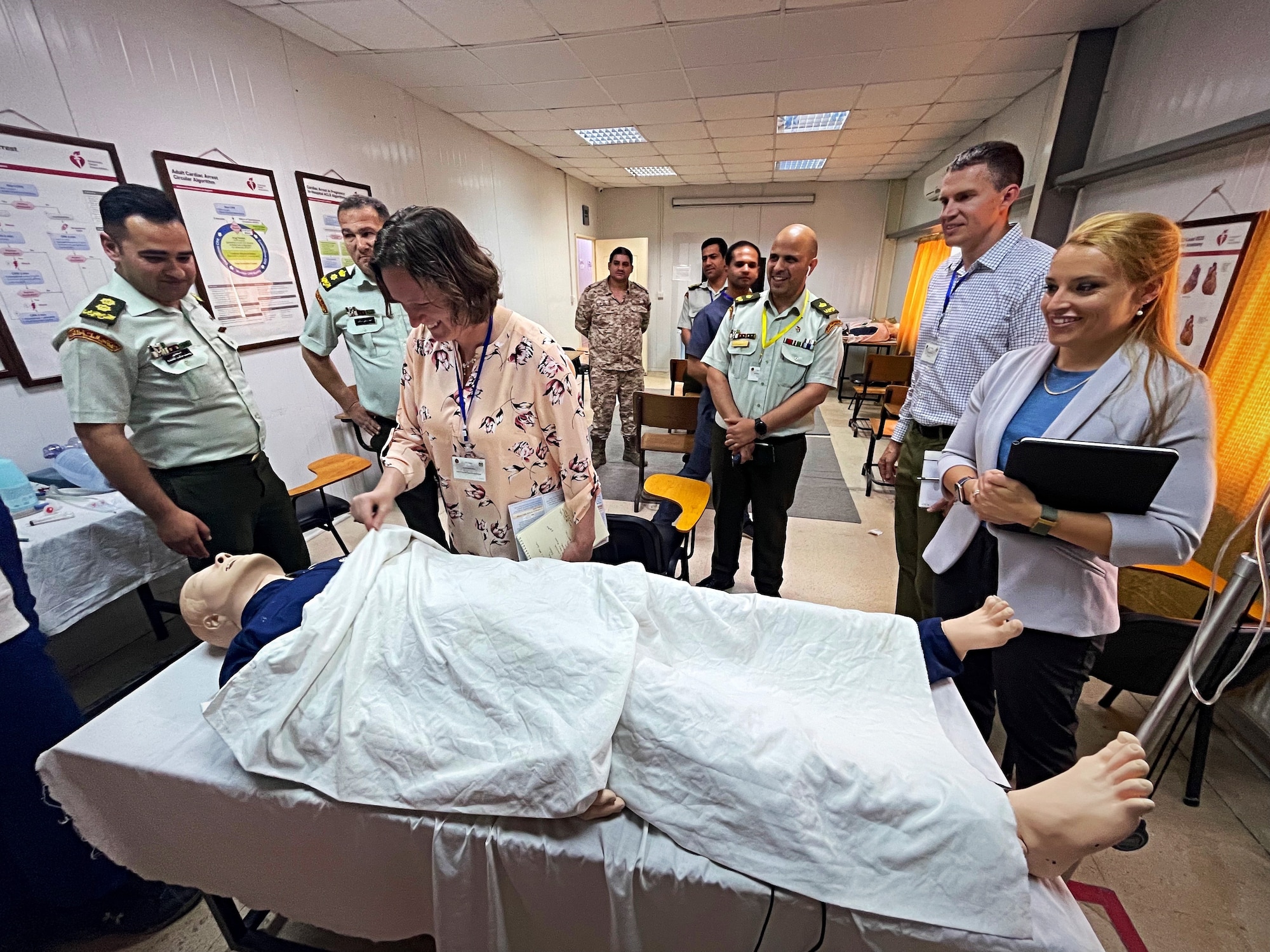 Lt. Col. Valerie Sams, Brooke Army Medical Center trauma medical director and clinical team lead for the partner nation trauma exchange, lifts a cover off of a medical practice dummy May 11, 2022 in Amman, Jordan.