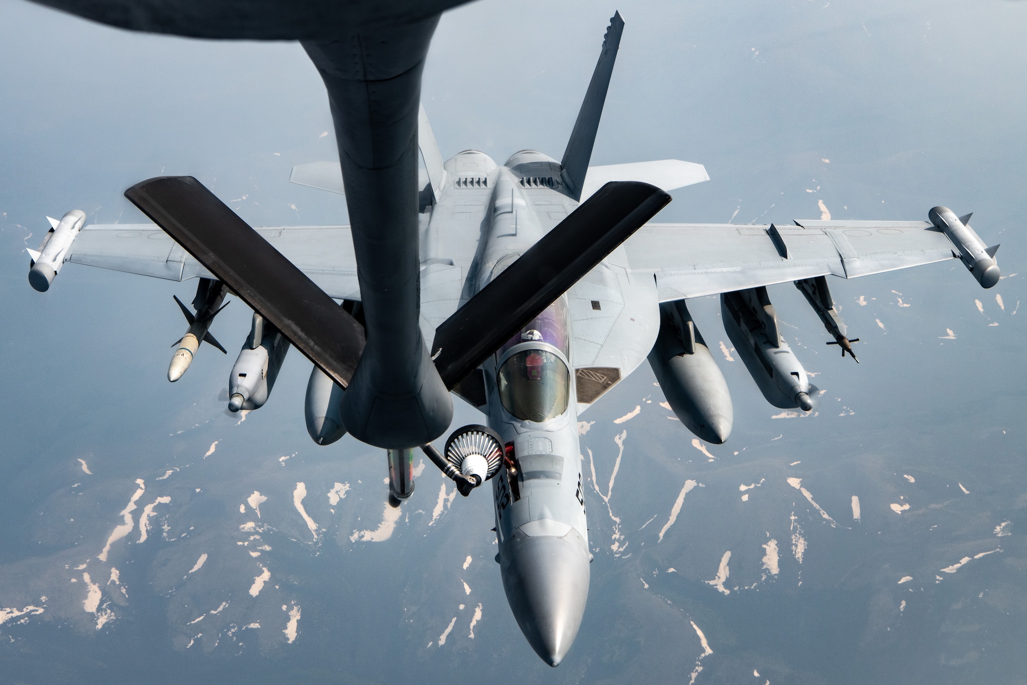 A Navy EA-18G performs an aerial refueling.