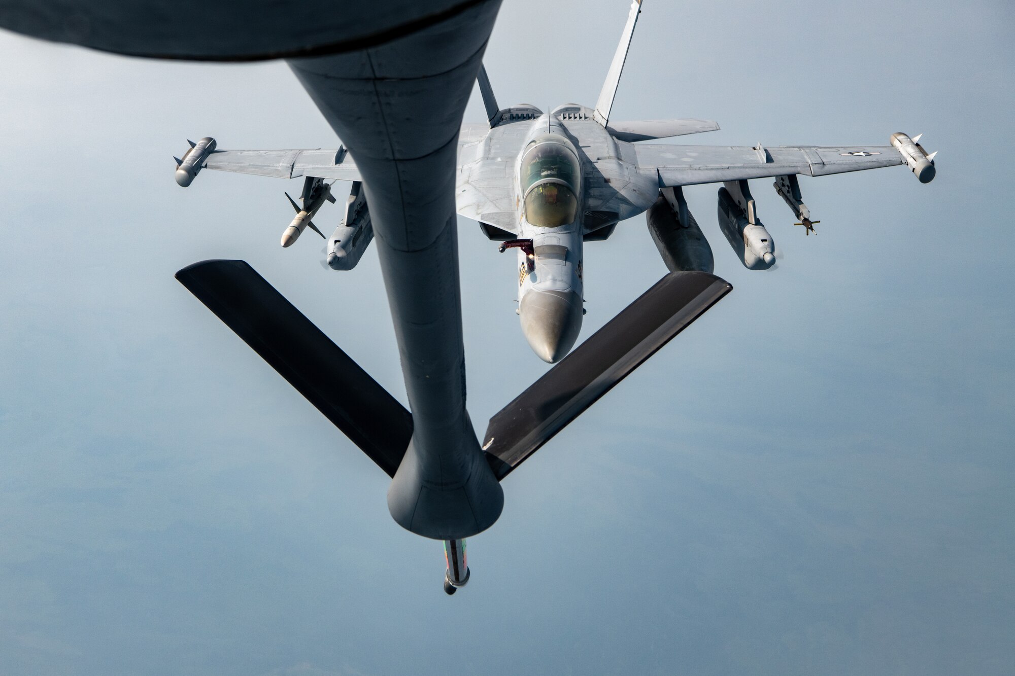 A Navy EA-18G performs an aerial refueling.