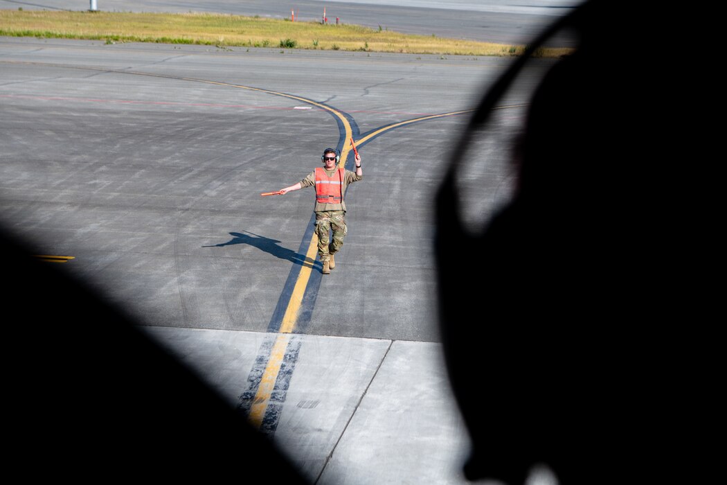 An Airman taxis a plane on the flight line.