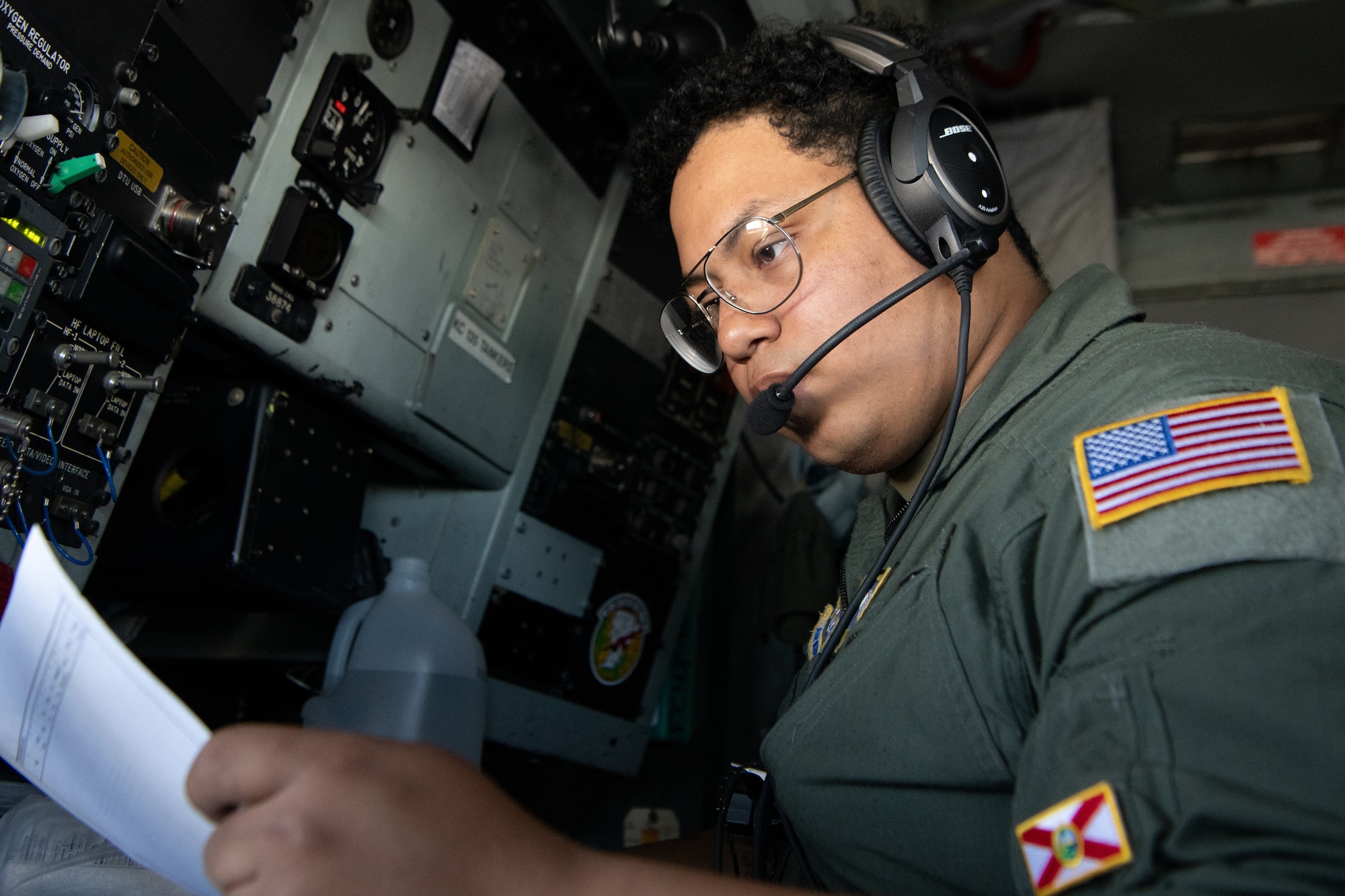 An Airman reads a checklist during preflight checks.