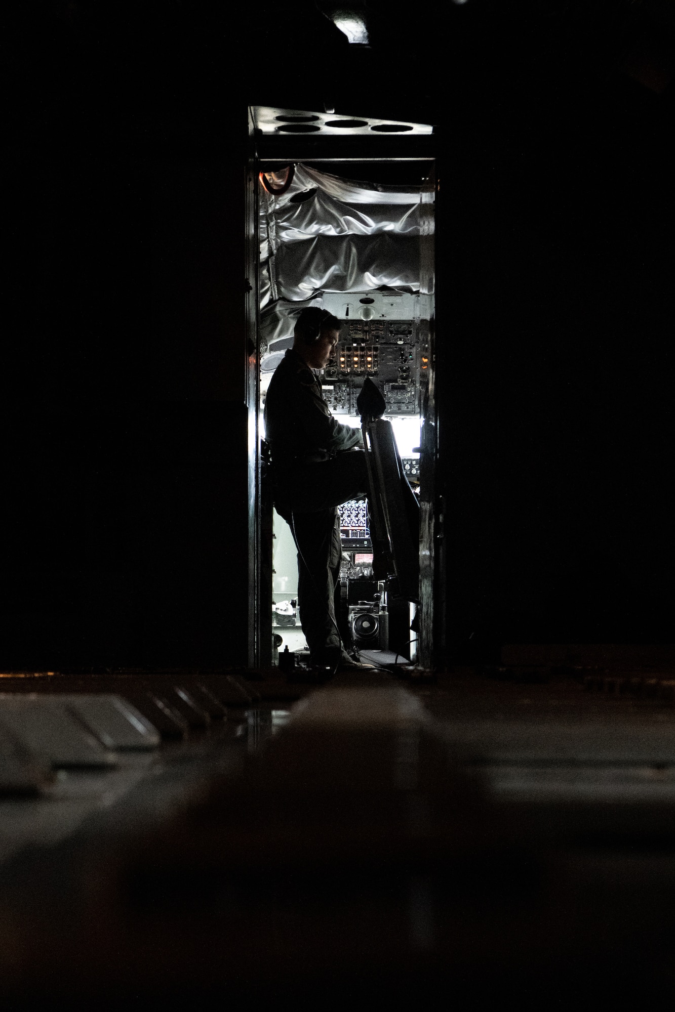 An Airman stands in the doorway on a KC-135.