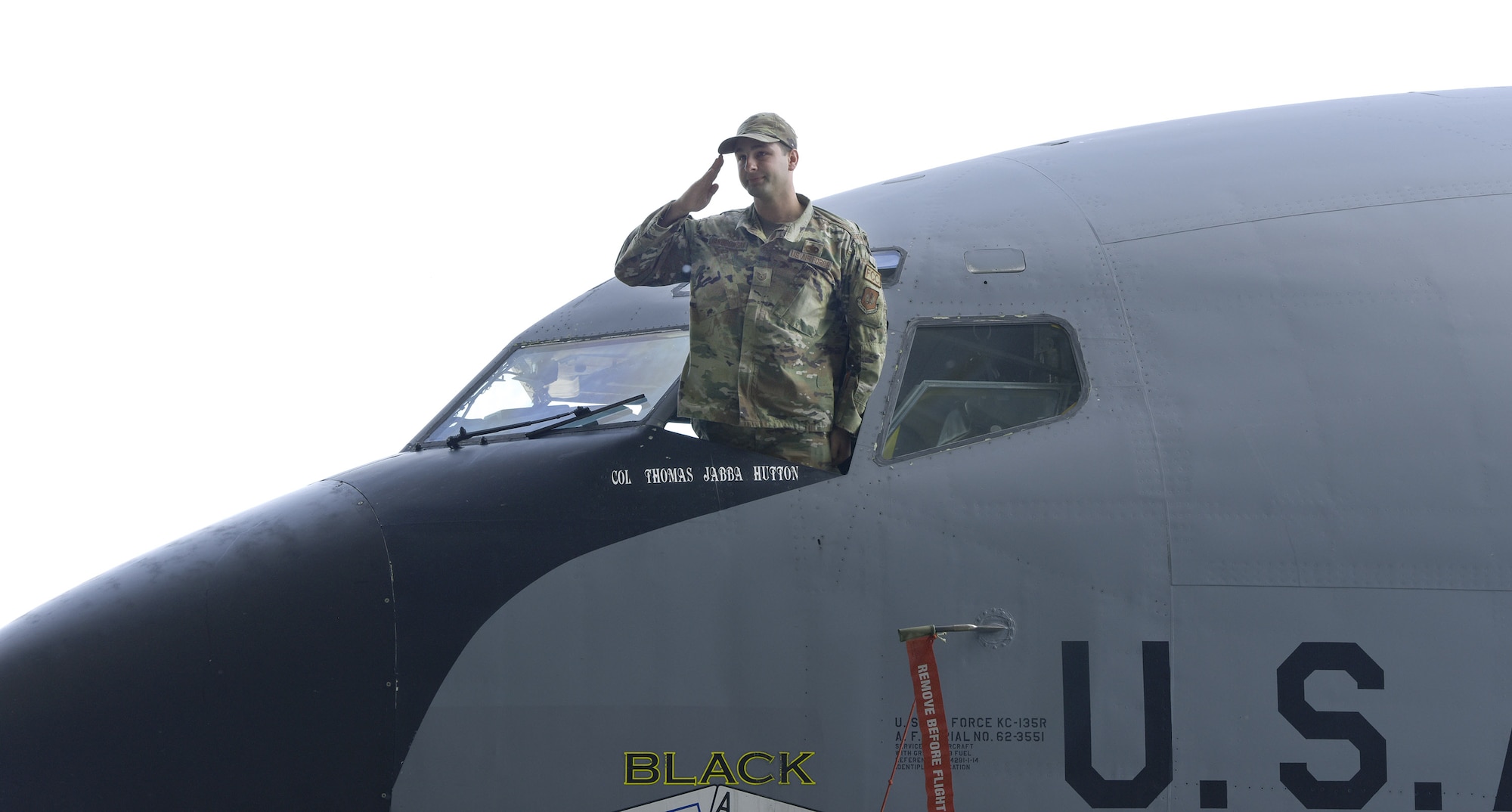 A U.S. Air Force Airman from the 100th Maintenance Group salutes new 100th Operations Group commander, Col. Thomas Hutton, after revealing the new commander’s name on a KC-135 Stratotanker during a change of command ceremony at Royal Air Force Mildenhall, England, June 16, 2022. Hutton joins the 100th Air Refueling Wing from Ramstein Air Base, Germany, and is a command pilot with more than 3,000 flying hours in tanker and trainer aircraft. (U.S. Air Force photo by Karen Abeyasekere)