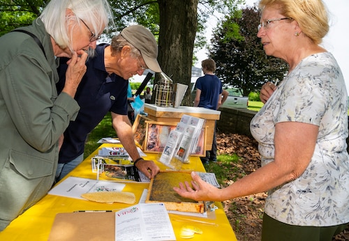Tate and Tim Maddy learn about beekeeping from Peggy Garnes, Ohio State Beekeepers Association president, at the annual Wright-Patterson Air Force Base, Ohio, Pollinator Expo, June 8, 2022, at the Wright Brothers monument. The expo sought to educate people about the important role pollinators play in nature and agriculture. (U.S. Air Force photo by R.J. Oriez)