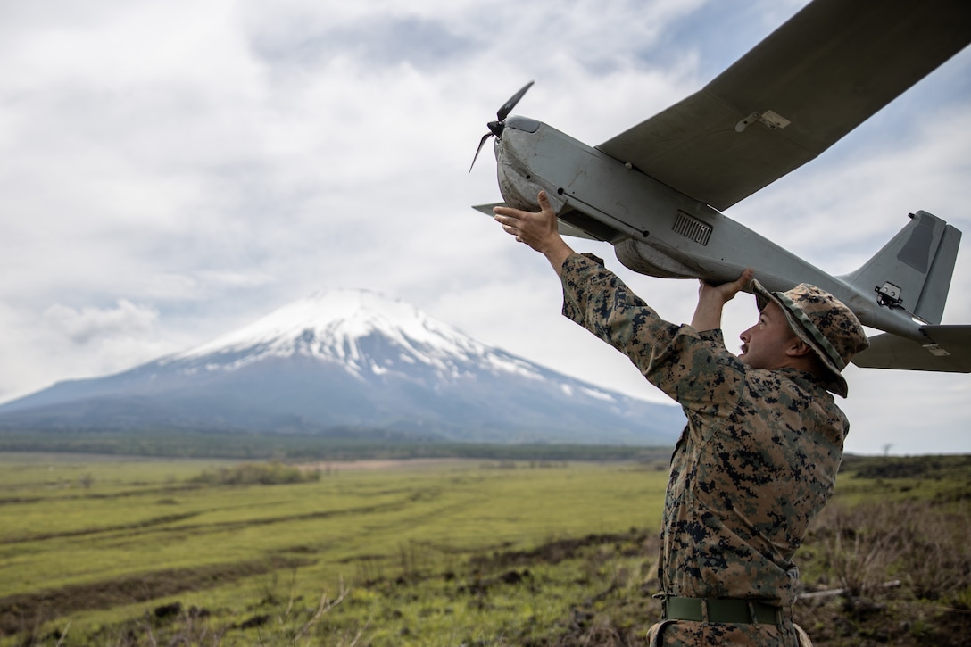 A Marine launches an unmanned aircraft.