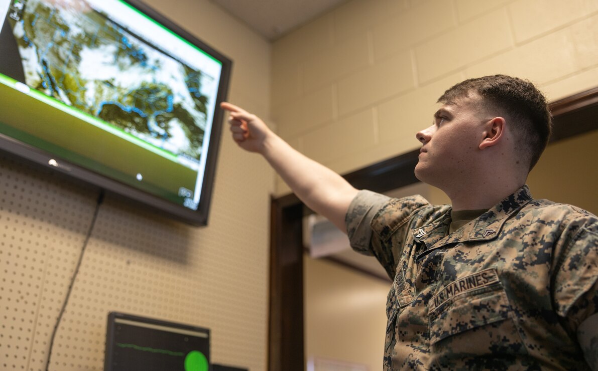 U.S. Marine Corps Cpl. Nathan Eubank, meteorology and oceanography (METOC) analyst forecaster with Headquarters and Headquarters Squadron (H&HS), points to a screen that tracks local weather patterns on Marine Corps Air Station (MCAS) New River in Jacksonville, North Carolina, June 1, 2022.