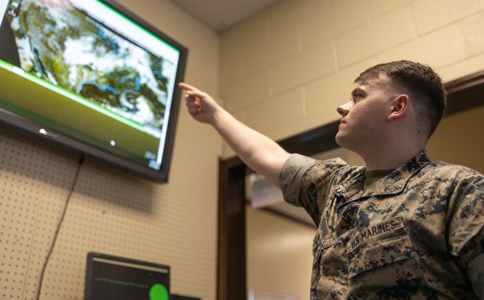 U.S. Marine Corps Cpl. Nathan Eubank, meteorology and oceanography (METOC) analyst forecaster with Headquarters and Headquarters Squadron (H&HS), points to a screen that tracks local weather patterns on Marine Corps Air Station (MCAS) New River in Jacksonville, North Carolina, June 1, 2022.