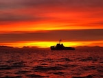 A view of the Coast Guard Cutter Steadfast at sunrise off the coast of San Diego, California., Dec. 2, 2019. The crew of the Steadfast was transiting north to their homeport of Astoria, Oregon, following a 60-day patrol in the Eastern Pacific Ocean. (U.S. Coast Guard photo by Petty Officer 1st Class Jonathan O'Connor.)