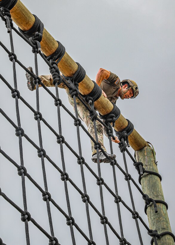 A United States team member climbs over an obstacle during the obstacle course for the Fuerzas Comando 2022 competition.