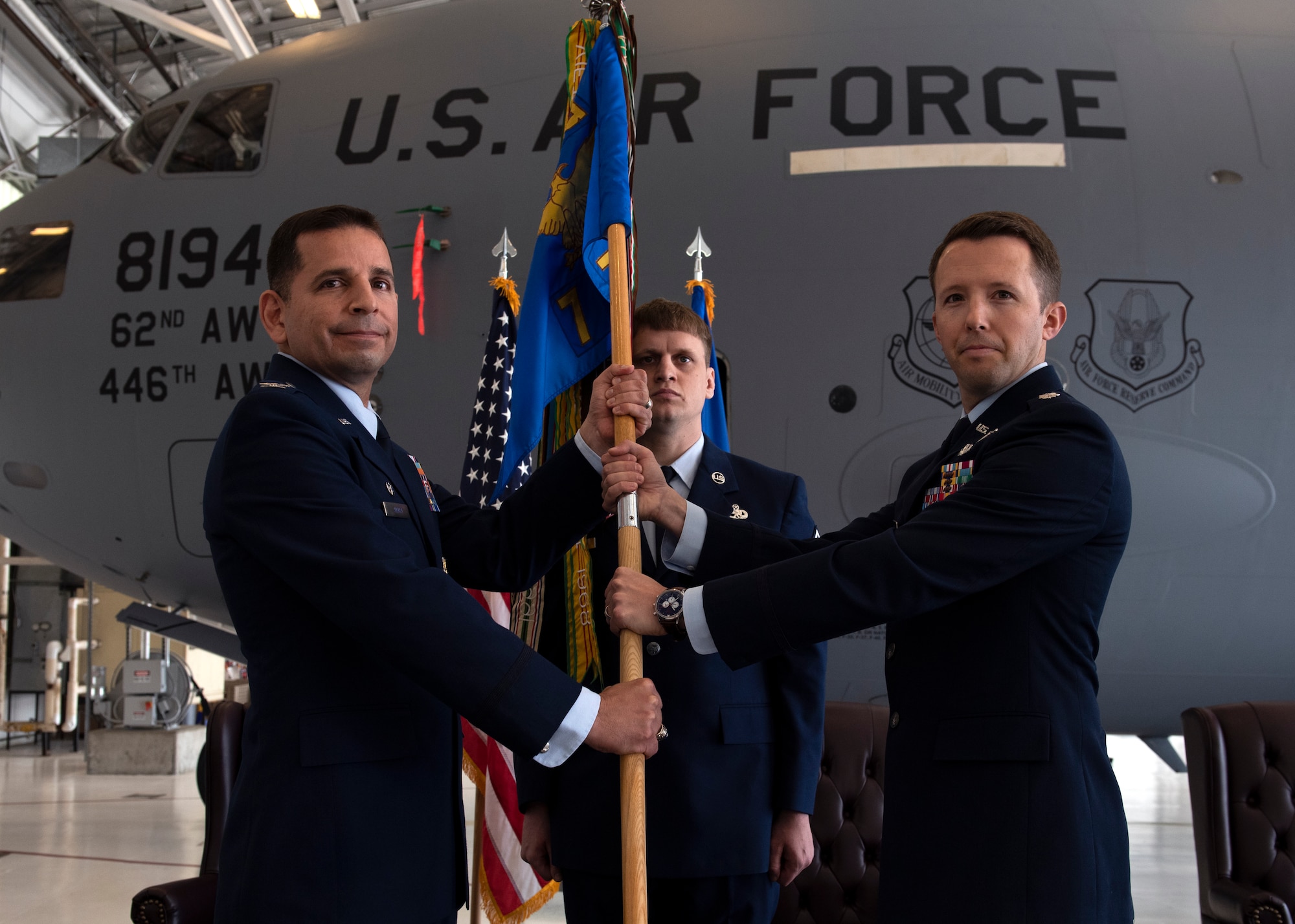 U.S. Air Force Lt. Col. Brandon Westling, right, commander of the 7th Airlift Squadron, assumes command from Col. Sergio Anaya, commander of the 62d Operations Group, during a change of command ceremony at Joint Base Lewis-McChord, Washington, June 16, 2022. Aircrews with the 7th AS operate the C-17 Globemaster III aircraft and have an impressive list of firsts; as they operated the first C-17 to land on Antarctic ice and the first C-17 to land in North Korea. (U.S. Air Force photo by Staff Sgt. Zoe Thacker)