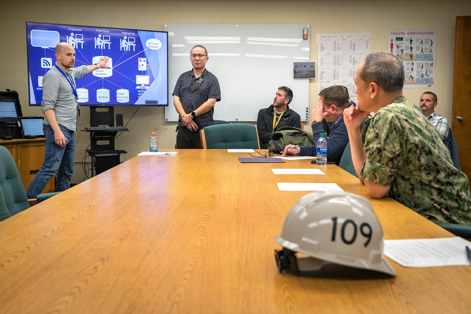 Rear Adm. Huan Nguyen, deputy commander for Cyber Engineering, Naval Sea Systems Command (NAVSEA) receives a briefing on the latest technology innovations May 19, 2022, at Puget Sound Naval Shipyard & Intermediate Maintenance Facility in Bremerton, Washington. (U.S. Navy photo by Scott Hansen)