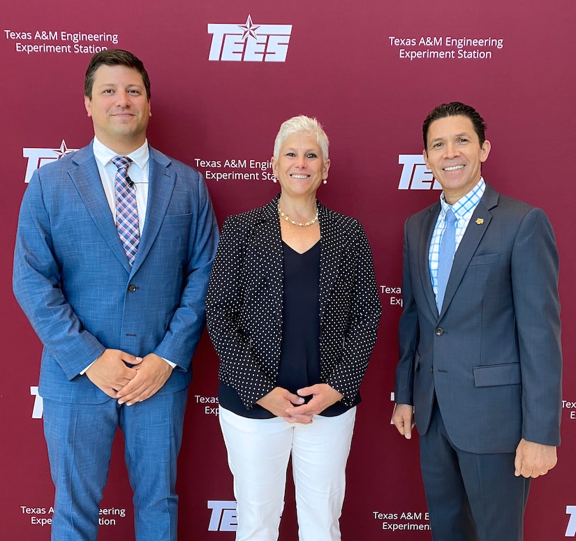 Three individuals stand shoulder-to-shoulder in front of a backdrop that says "Texas A&M Engineering Experiment Station."