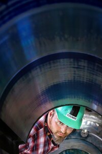 Carl Coombe, machinist supervisor, Shop 31, Machinists, Electroplaters & Toolmakers, examines the port rudder from USS Theodore Roosevelt (CVN 71) during tapering work. (U.S. Navy photo by Scott Hansen)